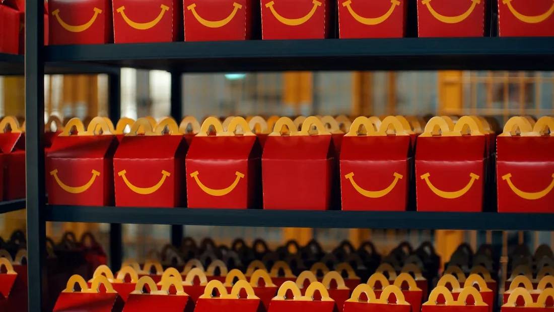 A row of happy meal boxes for McDonald's, one with a smile missing